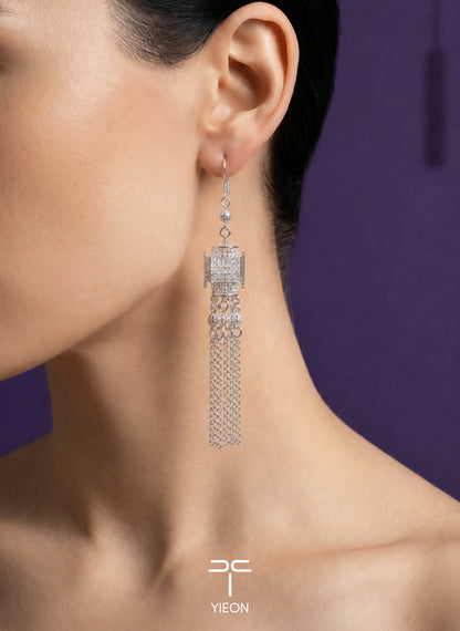 Palace Lantern: silver lantern-shaped earrings with long chain tassels; worn view.