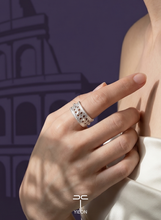 European Memory: a broad silver ring with repeated arches; worn view.