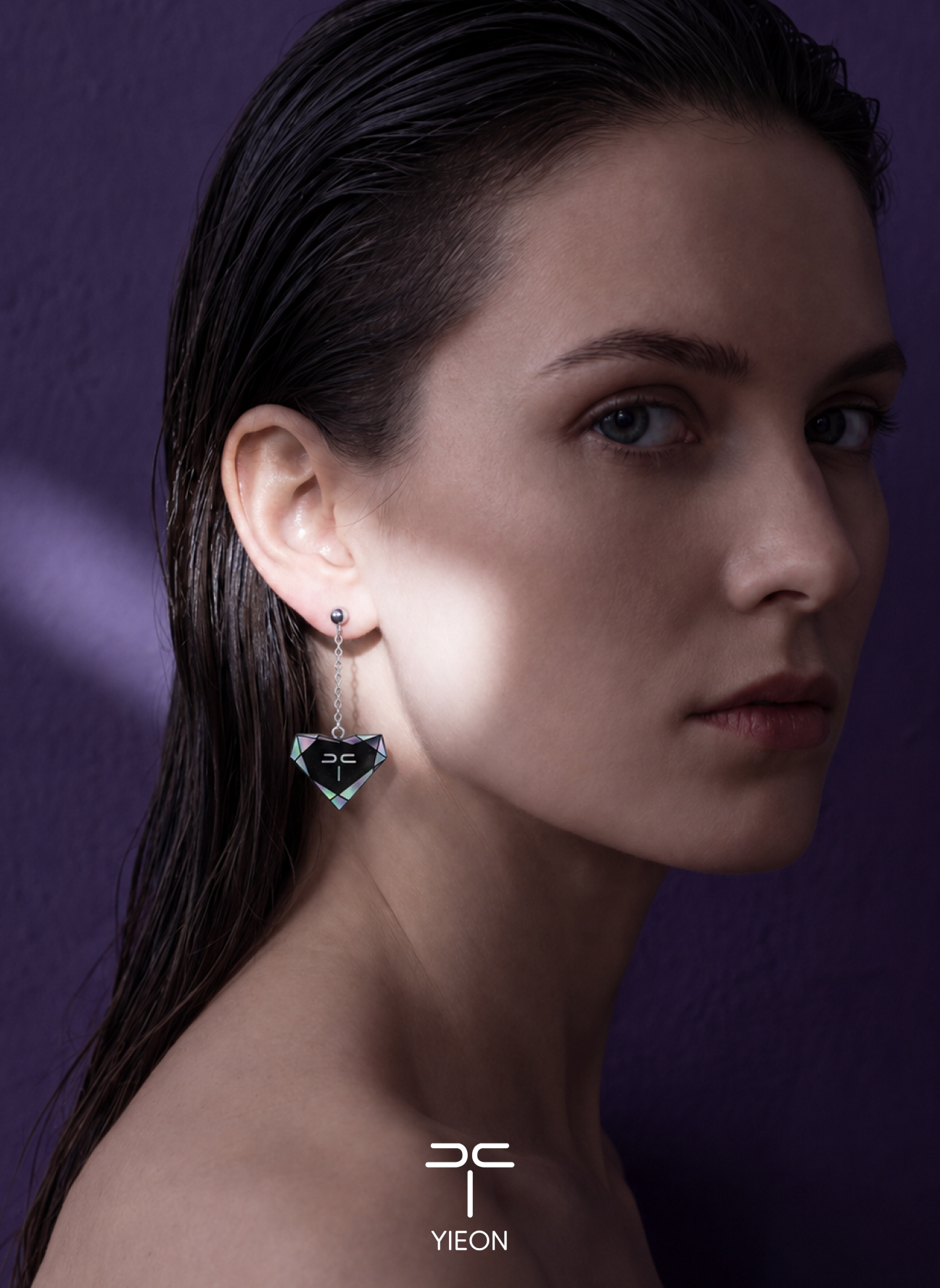 Model wearing the Iris black jade and mother-of-pearl chain-drop earring, with YIEON branding
