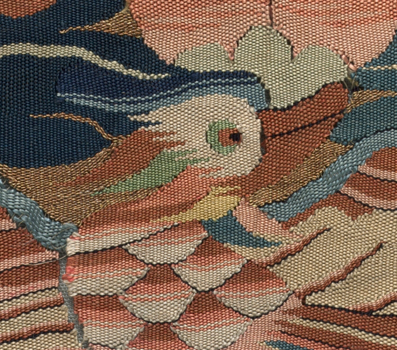 Close detail of a kesi silk rank badge with a crane and clouds.